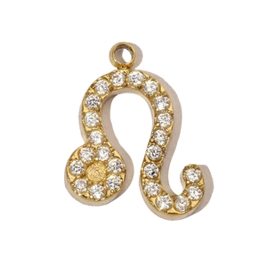 Macro shot of gold plated Leo zodiac pendant with inlaid cubic zirconia crystals