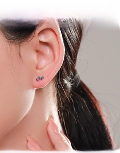 Macro view of minimalist S925 silver rainbow studs with three-color cubic zirconia