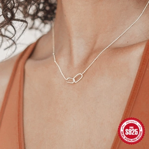 Close-up of S925 sterling silver U-shaped double interlocking rings on a delicate bead chain