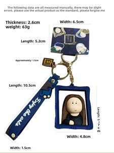 Detail view of Mona Lisa art keychain with blue wrist strap and miniature book ornament