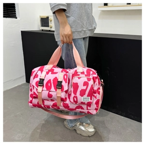 Pink leopard print sports gym bag with dual front pockets and adjustable shoulder strap