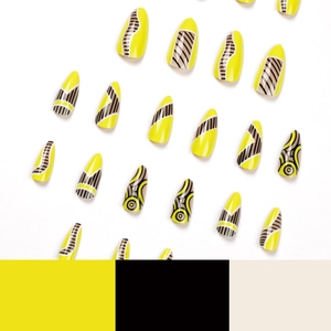 Almond press-on nails with yellow and black geometric pop art patterns on white background