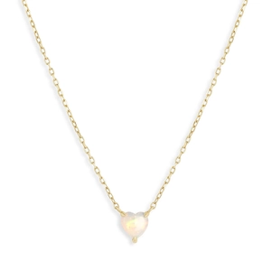 Detail of a golden thin chain necklace with a heart-shaped opal pendant and rainbow luster