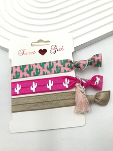 Detail of 3-piece elastic hair bands with cactus patterns and tassel on display card