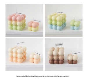 Detail of handmade cube bubble candle set with gradient colors in Nordic style