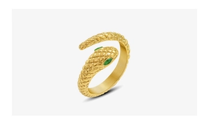 Detail of snake ring in 18k gold plating with green gemstone eyes and scale texture