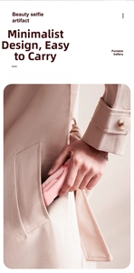 Pink portable selfie stick showing compact 18cm folded size fitting into a coat pocket