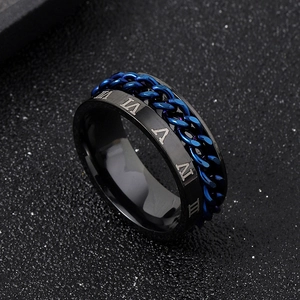Macro shot of black matte stainless steel ring with spinning blue chain and Roman numerals