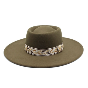 Detail of bohemian geometric ribbon band on olive green wool felt wide brim fedora hat