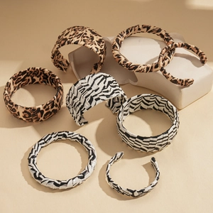 Chic animal print headbands in leopard and zebra patterns on a minimalist display