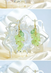Close-up of fresh green grape drop earrings with beaded texture and gold hooks on silk