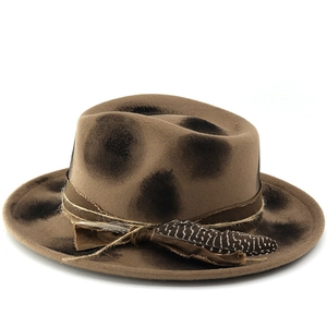 Close-up of brown distressed fedora hat featuring rustic hemp rope and a feather detail