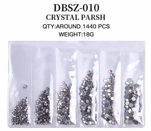 Detailed view of 1440pcs mixed size flatback crystal nail rhinestones in a 6-grid box