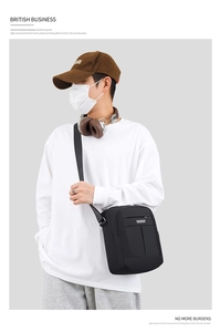 Men's black waterproof crossbody bag shown on model for a trendy urban casual look