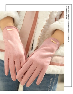 Close-up of pink faux suede winter gloves featuring metal plate decor and soft texture