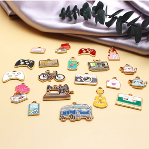 Macro detail of various vintage alloy enamel charms including retro cameras and gamepads