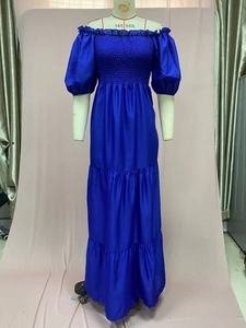 Close-up of royal blue off-shoulder dress with elastic bodice and tiered skirt
