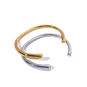 Minimalist C-shaped stainless steel bracelets in gold and silver finish on white background