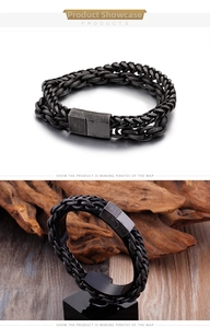 Detail of men's double-layer black stainless steel woven chain bracelet with metal clasp