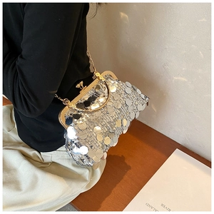 Detail of silver sequin evening bag with gold metal clasp and chain strap for evening dresses