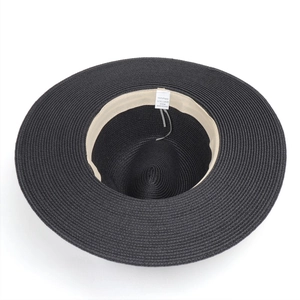 Detail view of woven paper sun hat interior showing sweatband and 57cm size label