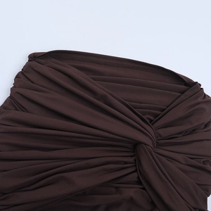 Detailed close-up of front twist knot and draped fabric on dark coffee knit dress