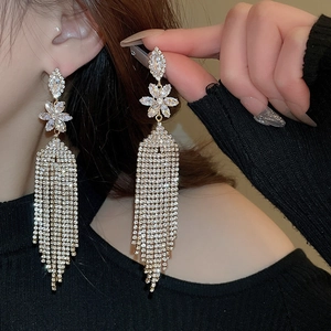 Close-up of sparkling rhinestone flower tassel earrings with long dangling crystal fringe