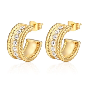 Close-up of gold twisted hoop earrings with sparkling inlaid rhinestones and stud backs