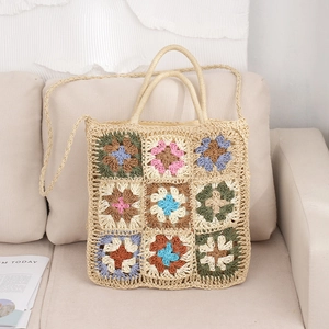 Handmade granny square crochet tote bag with colorful floral patterns and shoulder strap