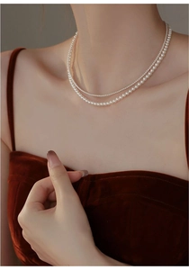 Close-up of double-layer freshwater pearl necklace with 14K gold-filled details on neck
