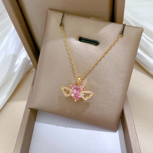 Titanium steel necklace with pink heart pendant and golden crystal wings in a jewelry box