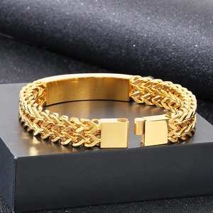 Macro view of gold-plated hip-hop bracelet with woven texture and magnetic clasp