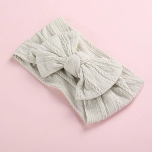 Detailed macro view showing the soft cable knit texture of this baby bow headband.