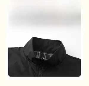 Detail of black stand-up collar jacket showing plaid lining and smooth metal zipper