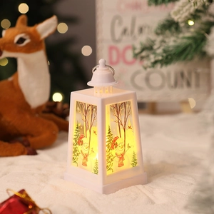 Close-up of white Christmas lantern with snowman patterns and warm LED light