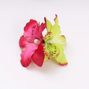 Detail of bohemian faux cymbidium hair clips with magenta and green petals and white stamens