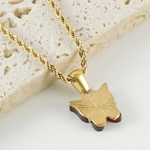 Golden butterfly pendant necklace with sunburst texture on a twisted rope chain