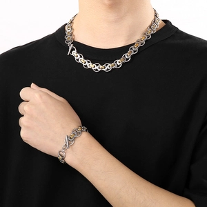 Detail of two-tone silver and gold Byzantine chain necklace and bracelet with toggle clasp