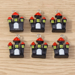 Detail of 6 mini Halloween castle alloy charms on wooden background for DIY jewelry