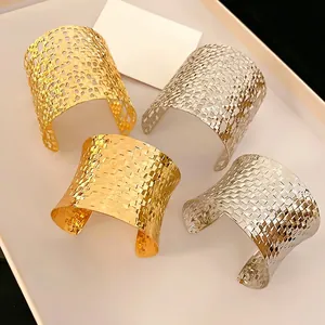 Gold and silver woven open bangles featuring hollow honeycomb and textured metal designs