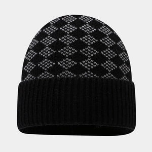 Detailed view of winter knit beanie with black and grey diamond patterns and folded brim