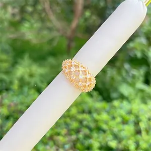 Detail of 18K gold plated mesh ring featuring crisscross lattice and sparkling zircons