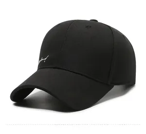 Close-up of a black cotton baseball cap with white cursive letter embroidery and eyelets