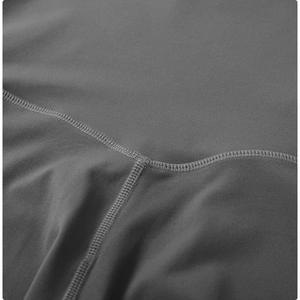Macro shot of dark grey yoga pants featuring high-elastic knit fabric and V-shaped waist