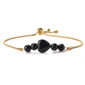 Detail of adjustable 14K gold box chain bracelet with blue galaxy sand heart and beads