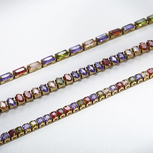 Close-up of 18K gold plated titanium necklaces with colorful geometric square gemstones