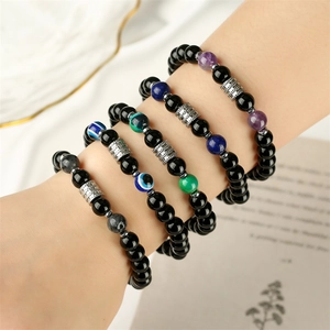 Stack of men's beaded bracelets featuring black stones and colorful accent tiger eye beads