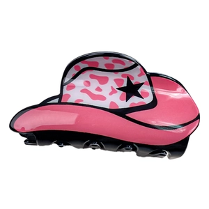 Pinza per capelli a cappello da cowboy rosa con stelle nere e macchie su sfondo bianco