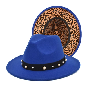 Detail of blue wool fedora featuring leopard print brim lining and pearl hat band trim