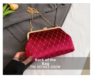 Detail view of red velvet quilted evening bag with sparkling rhinestone diamond pattern